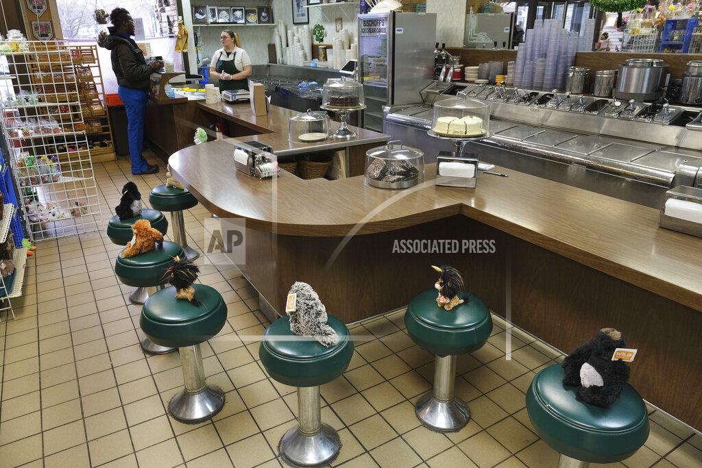 Seth Wenig FILE - In this March 16, 2020, file photo, stuffed animals resting on the stools at Bischoff's, an ice cream parlor in Teaneck, N.J., serve as a gentle reminder that customers are not allowed to sit down. (AP Photo/Seth Wenig, File)