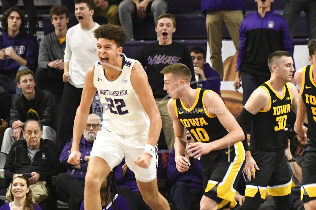 David Banks Northwestern forward Pete Nance (22) reacts after dunking next to Iowa guard Joe Wieskamp (10) during the first half of an NCAA college basketball game Tuesday, Jan. 14, 2020, in Evanston, Ill. (AP Photo/David Banks)