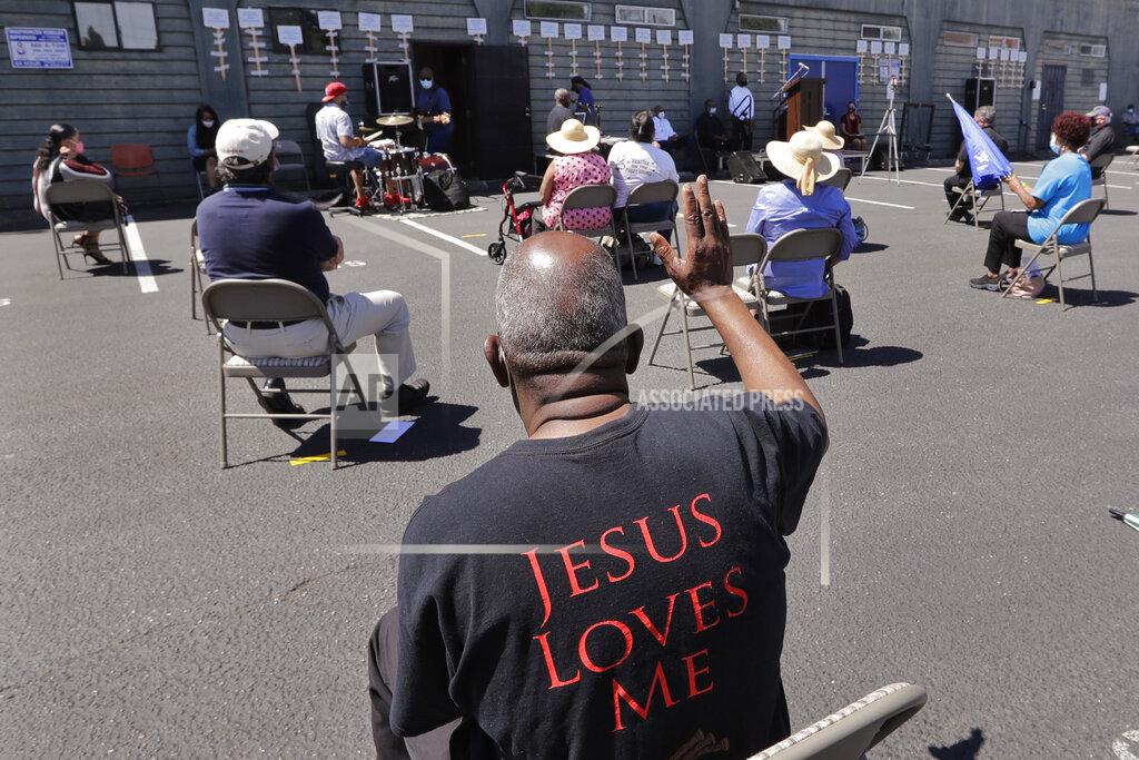 Elaine Thompson FILE - In this Sunday, July 19, 2020 file photo, church parishioners sit apart socially distanced at a prayer vigil for racial justice at Immaculate Conception Catholic Church in Seattle. The vigil follows ongoing protests over the death of George Floyd, a Black man who died in police custody in Minneapolis. (AP Photo/Elaine Thompson)