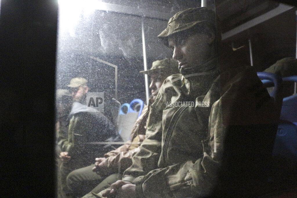 Uncredited Ukrainian servicemen sit in a bus after they left the besieged Mariupol's Azovstal steel plant, near a penal colony in Olyonivka, in territory under the government of the Donetsk People's Republic, eastern Ukraine, Friday, May 20, 2022. (AP Photo)