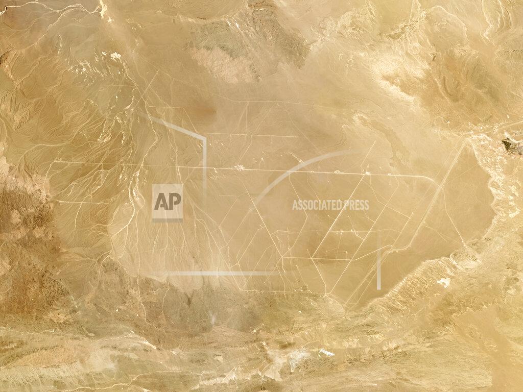 Planet Labs Inc. This composite photo of satellite images taken in June 2021 provided by Planet Labs Inc. shows what analysts believe is a field of intercontinental ballistic missile silos near Hami, China. The U.S. military is warning about what analysts have described as a major expansion of China's nuclear missile silo fields, at a time of heightened tension between the U.S. and China. (Planet Labs Inc. via AP)