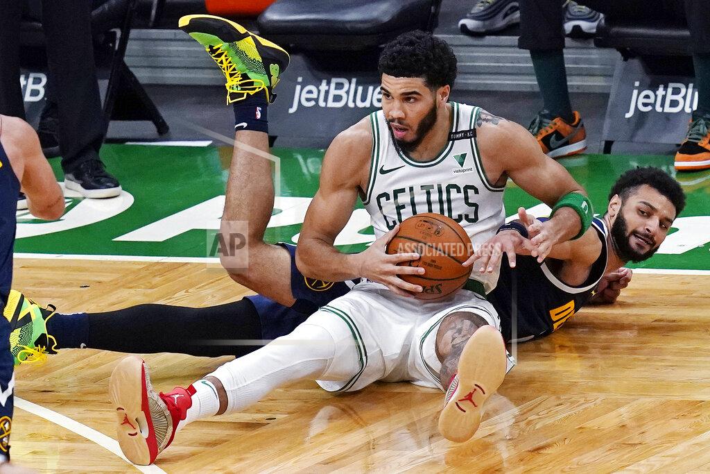 Charles Krupa Denver Nuggets guard Jamal Murray, right, stretches for the ball as Boston Celtics forward Jayson Tatum, center, gains control during the first half of an NBA basketball game, Tuesday, Feb. 16, 2021, in Boston. (AP Photo/Charles Krupa)