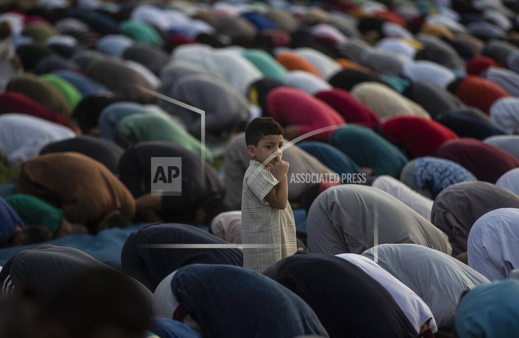 Khalil Hamra Palestinian Muslims attend the prayer of the first day of Eid al-Adha in Gaza City, Tuesday, July. 20, 2021. (AP Photo/Khalil Hamra)