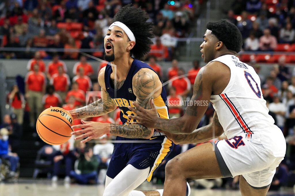 Butch Dill Murray State guard Tevin Brown (10) drives to the basket around Auburn guard K.D. Johnson (0) during the first half of an NCAA college basketball game Wednesday, Dec. 22, 2021 in Auburn, Ala. (AP Photo/Butch Dill)
