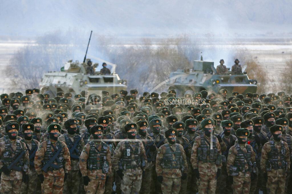 Uncredited FILE - In this Jan. 4, 2021, file photo, Chinese soldiers rally while training in -20 degrees Celsius (-4 degrees Fahrenheit) conditions in Kashgar in northwestern China's Xinjiang Uighur Autonomous Region. An official from China's Communist Party signaled last December that there would likely be no letup in its crackdown in the remote Xinjiang region, but said the government's focus is shifting more to addressing the roots of extremism. This year's annual congress meeting comes as China and the U.S. are attempting to soften the caustic tone in relations that prevailed during the Trump administration. While President Joe Biden is maintaining pressure over trade and technology, he has shown a willingness to restore dialogue. However, China has not shown any willingness to budge in the face of U.S. support for Taiwan and criticism of Beijing's policies in Hong Kong, Tibet and Xinjiang. (Chinatopix Via AP, File)