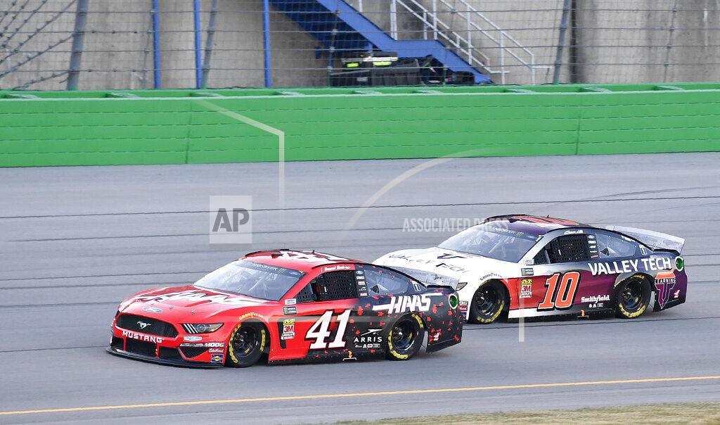 Timothy D. Easley Daniel Suarez (41) tries to hold off Aric Almirola (10) during the NASCAR Cup Series auto race at Kentucky Speedway in Sparta, Ky., Saturday, July 13, 2019. (AP Photo/Timothy D. Easley)