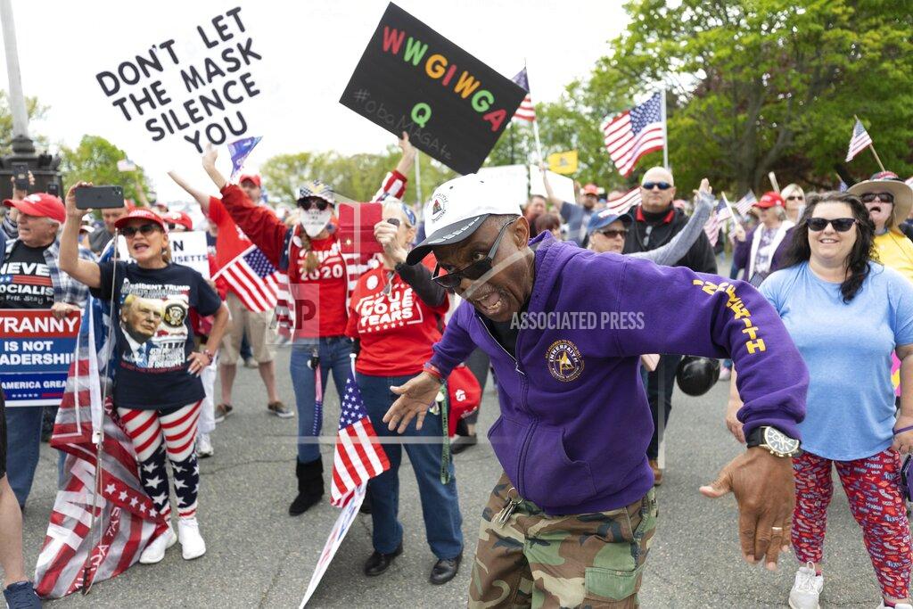Michael Dwyer People demonstrate against state restrictions imposed over concern about COVID-19 near the residence of Gov. Charlie Baker, Saturday, May 16, 2020, in Swampscott, Mass. (AP Photo/Michael Dwyer)