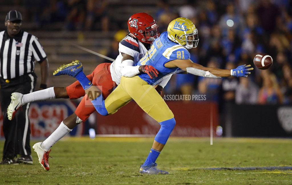 Mark J. Terrill UCLA tight end Caleb Wilson, right, can't reach a pass while under pressure from Arizona safety Demetrius Flannigan-Fowles during the second half of an NCAA college football game Saturday, Oct. 20, 2018, in Pasadena, Calif. UCLA won 31-30. (AP Photo/Mark J. Terrill)