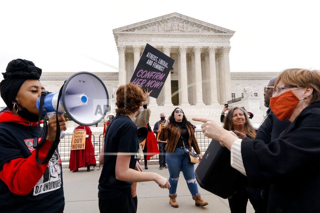 Jacquelyn Martin People demonstrate for and against the nomination of Amy Coney Barrett to the Supreme Court, Monday, Oct. 26, 2020, outside the Supreme Court on Capitol Hill in Washington. (AP Photo/Jacquelyn Martin)