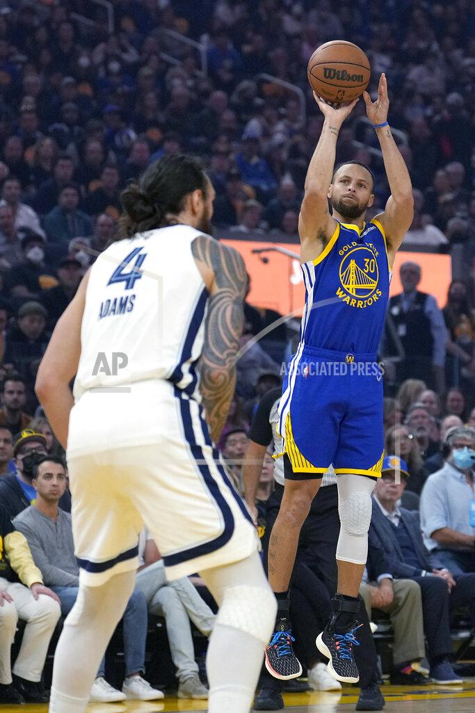 Tony Avelar Golden State Warriors guard Stephen Curry (30) takes a 3-point shot over Memphis Grizzlies center Steven Adams (4) during the first half of Game 6 of an NBA basketball Western Conference playoff semifinal in San Francisco, Friday, May 13, 2022. (AP Photo/Tony Avelar)