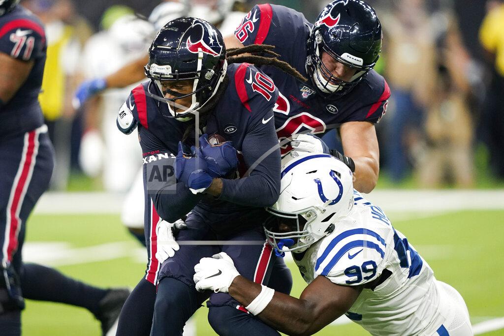 David J. Phillip Houston Texans wide receiver DeAndre Hopkins (10) is hit by Indianapolis Colts defensive end Justin Houston (99) after a catch during the first half of an NFL football game Thursday, Nov. 21, 2019, in Houston. (AP Photo/David J. Phillip)
