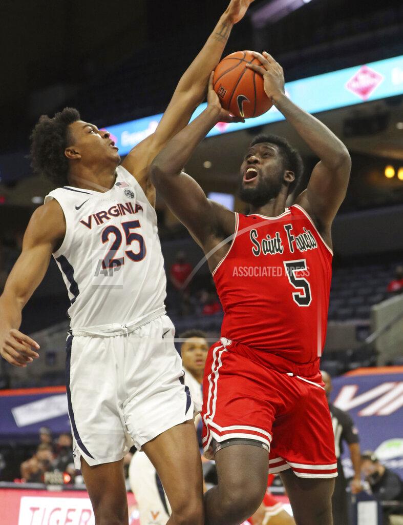 Andrew Shurleff St. Francis forward Myles Thompson (5) is fouled by Virginia guard Trey Murphy III (25) during an NCAA college basketball game, Tuesday, Dec. 1, 2020 in Charlottesville, Va. (Andrew Shurleff/The Daily Progress via AP)