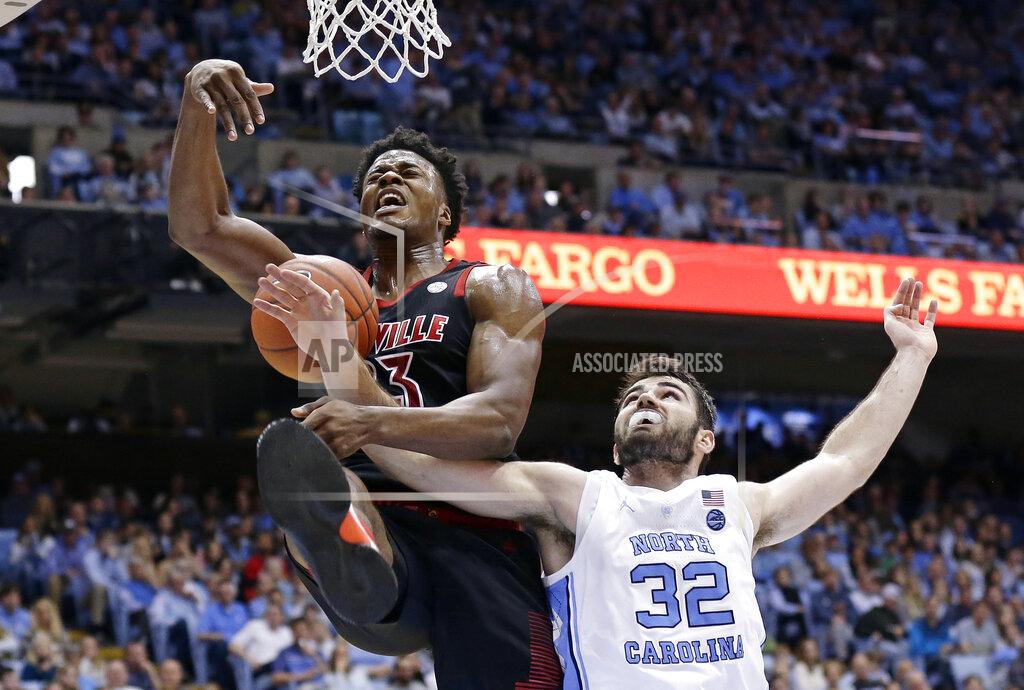Gerry Broome North Carolina's Luke Maye (32) reaches in while Louisville's Steven Enoch (23) drives to the basket during the second half of an NCAA college basketball game in Chapel Hill, N.C., Saturday, Jan. 12, 2019. Louisville won 83-62. (AP Photo/Gerry Broome)