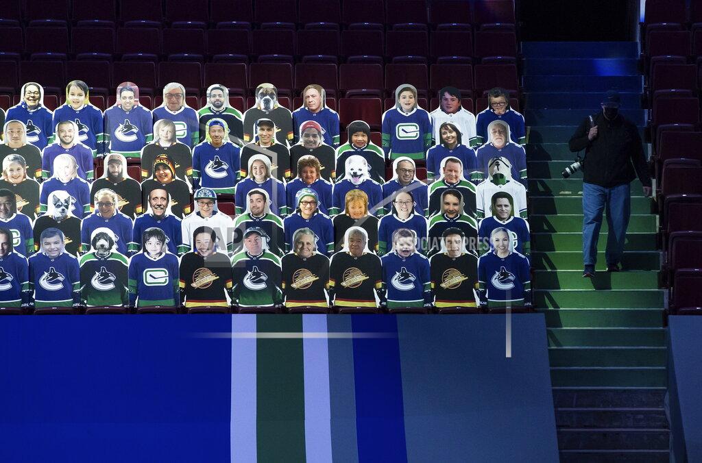 Cardboard cutouts of fans are displayed in the seats before an NHL hockey game between the Vancouver Canucks and the Toronto Maple Leafs in Vancouver, British Columbia, Sunday, April 18, 2021. (Darryl Dyck/The Canadian Press via AP)