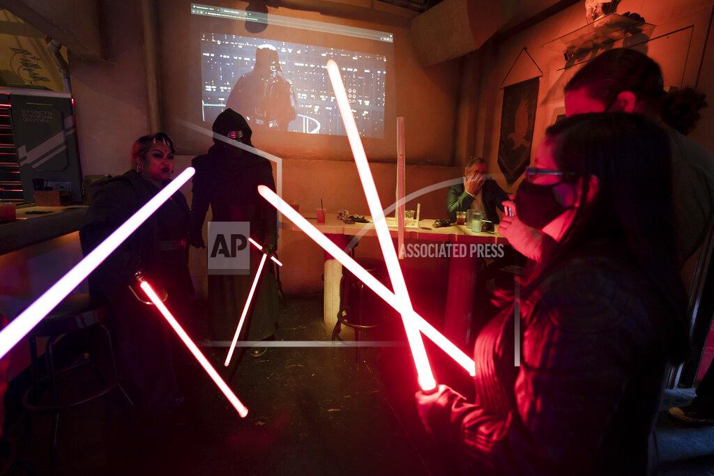 Jae C. Hong Fans celebrate Star Wars Day at Scum and Villainy Cantina, a geek bar located on Hollywood Boulevard in Los Angeles, Tuesday, May 4, 2021. California has the lowest coronavirus infection rate in the country. Los Angeles County, which is home to a quarter of the state's nearly 40 million people and has endured a disproportionate number of the state's 60,000 deaths, didn't record a single COVID-19 death Sunday or Monday, which was likely due to incomplete weekend reporting but still noteworthy. (AP Photo/Jae C. Hong)