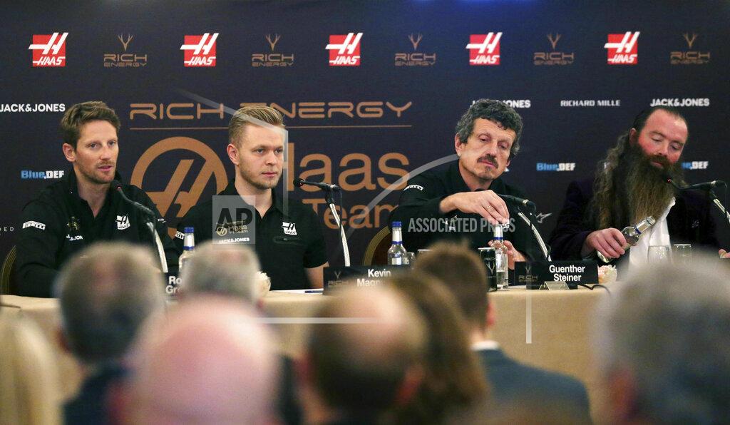 Steven Paston The launch of the new car for Rich Energy Haas F1 Team 2019, with from left, Romain Grosjean, Kevin Magnussen, Team Principal Guenther Steiner and Rich Energy CEO William Storey, at the Royal Automobile Club in London, Thursday Feb. 7, 2019. (Steven Paston/PA via AP)