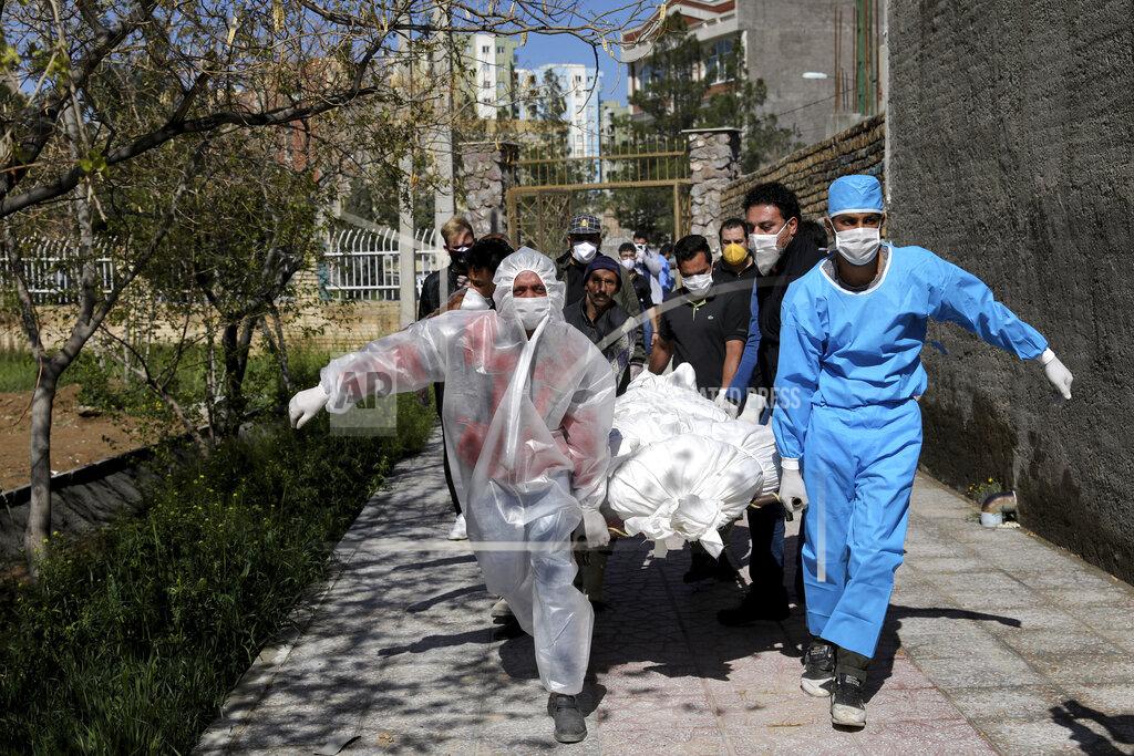 Ebrahim Noroozi FILE - In this Monday, March 30, 2020 file photo, people carry the body of a victim who died after being infected with the new coronavirus at a cemetery just outside Tehran, Iran. Across the Middle East and parts of South Asia, bereaved families have faced traumatic restrictions on burying their dead amid the pandemic. Religion and customs that require speedy burials in the largely Muslim region have clashed with fears of COVID-19 contagion and government-mandated lockdowns. (AP Photo/Ebrahim Noroozi, File)