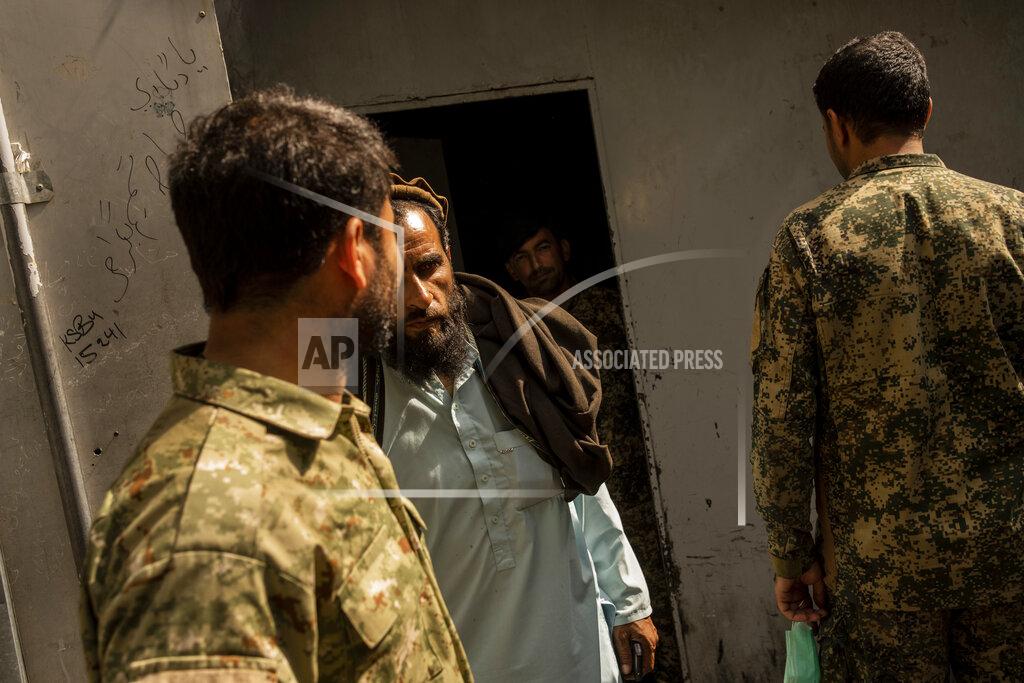 Bernat Armangue An Afghan man walks out of the bank after withdrawing money in Kabul, Afghanistan, Sunday, Sept. 12, 2021. (AP Photo/Bernat Armangue)