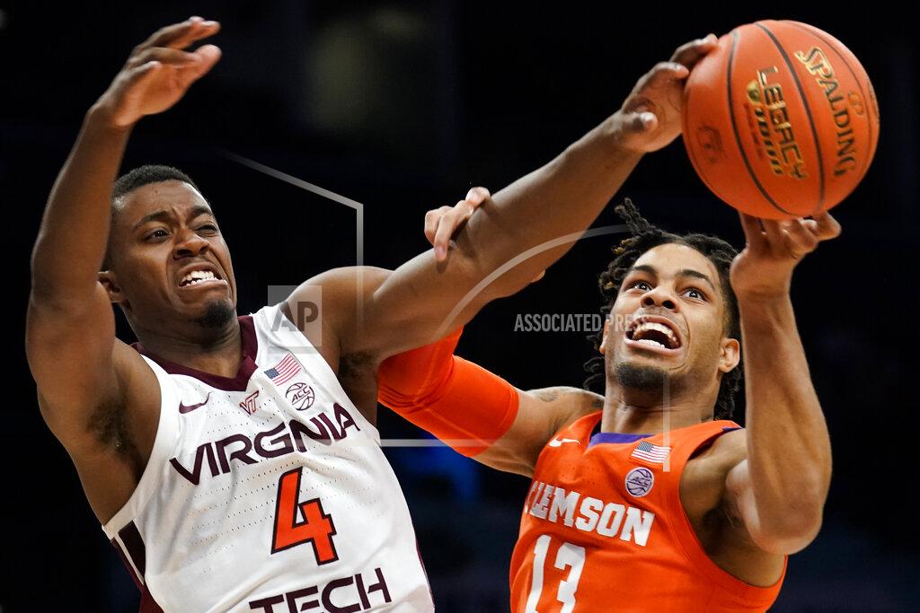 John Minchillo Clemson Tigers' David Collins (13) and Virginia Tech's Nahiem Alleyne (4) battle for a rebound in the first half of an NCAA college basketball game during the Atlantic Coast Conference men's tournament, Wednesday, March 9, 2022, in New York. (AP Photo/John Minchillo)
