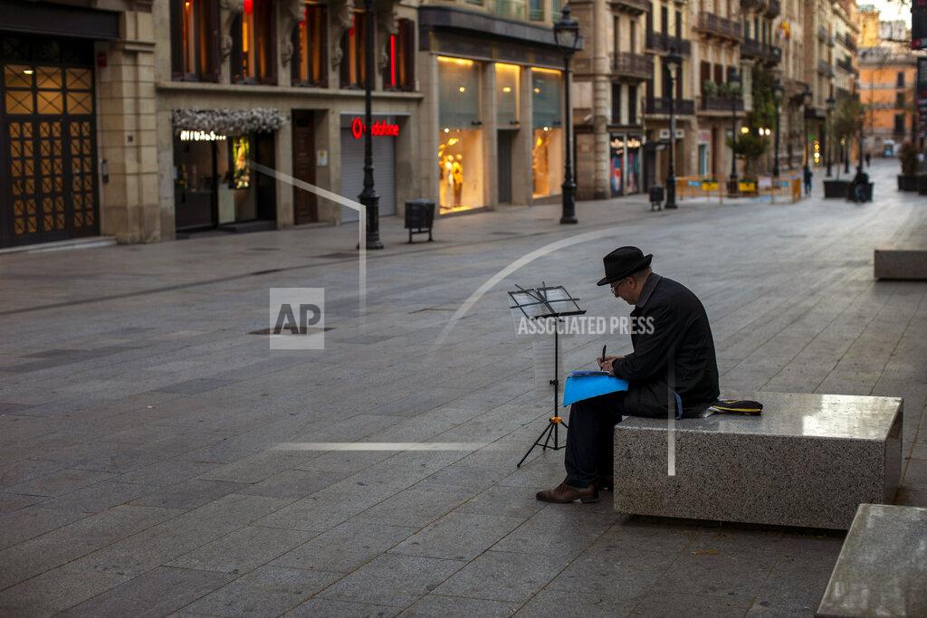 Emilio Morenatti FILE - In this Sunday, March 15, 2020 file photo, a man sits, in an empty street in Barcelona, Spain. The European Union on Tuesday, April 21, 2020 says its vaunted tourism industry is facing decline due to the coronavirus crisis while Internal market Commissioner Thierry Breton says it should be the prime sector to receive over a fifth of all recovery funds. (AP Photo/Emilio Morenatti, File)