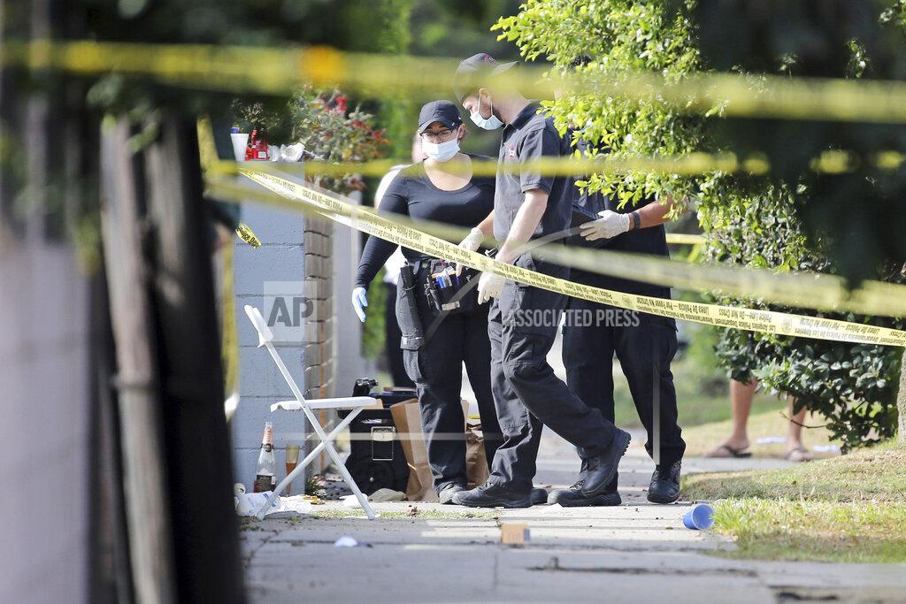 Reed Saxon FILE - In this Oct. 15, 2016 file photo, Los Angeles police investigators work the scene of a fatal shooting in the Crenshaw District of Los Angeles. Detectives nationwide are grappling with changes the coronavirus has wrought on their investigations. Cold cases are getting colder, plainclothes investigators are digging out their dusty uniforms for patrol duty, and detectives are struggling to find new ways to connect with victims through thick masks. Even as police departments report major decreases in crime statistics thanks to stay-at-home orders, authorities say enough wrongdoing abounds to keep cops busy. And some detective work must still be in-person and hands-on, despite COVID-19. (AP Photo/Reed Saxon, File)