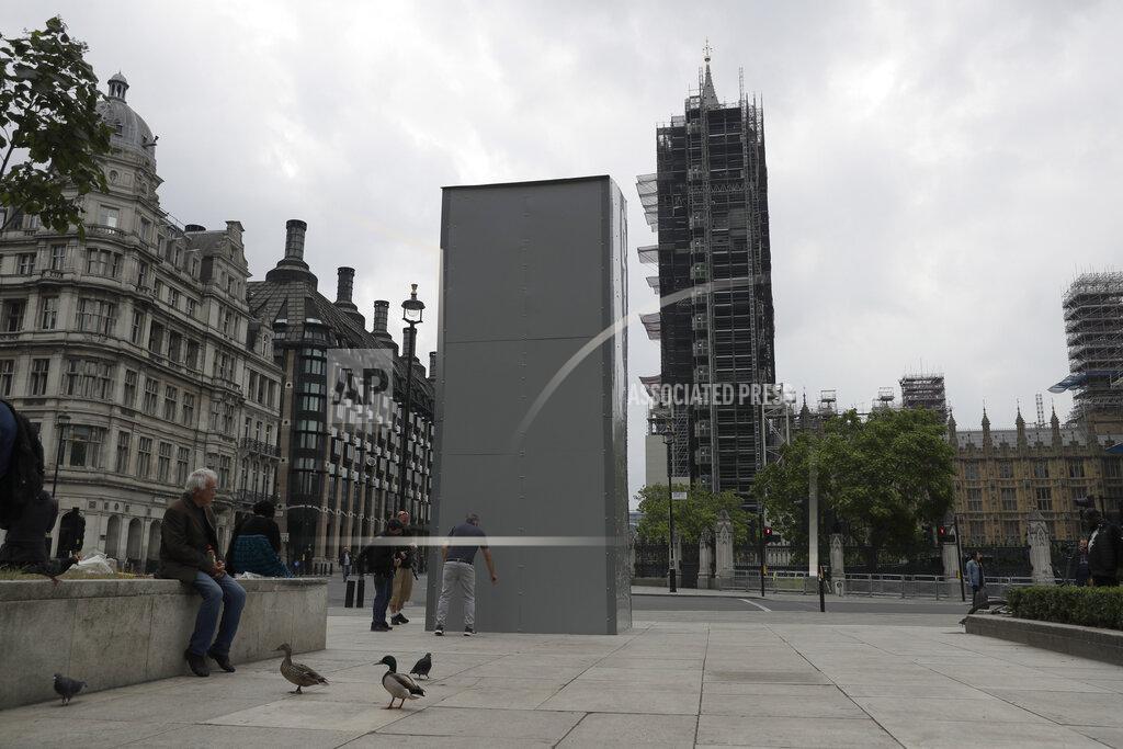 Matt Dunham A protective screen put up late Thursday encloses the statue of Britain's World War II Prime Minister Winston Churchill, backdropped by the Houses of Parliament, ahead of expected rival demonstrations by anti-racism and far-right protesters in London, Friday, June 12, 2020. Last Sunday the statue was daubed with the words "was a racist" during a protest against racism and police violence after the May 25 death of George Floyd, a black man who died after a white Minneapolis U.S. police officer pressed a knee to his neck. (AP Photo/Matt Dunham)