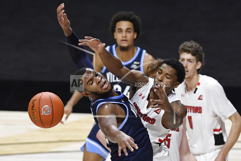 Jessica Hill Villanova's Eric Dixon, left, and Hartford's Moses Flowers reach for a loose ball in the first half of an NCAA college basketball game, Tuesday, Dec. 1, 2020, in Uncasville, Conn. (AP Photo/Jessica Hill)