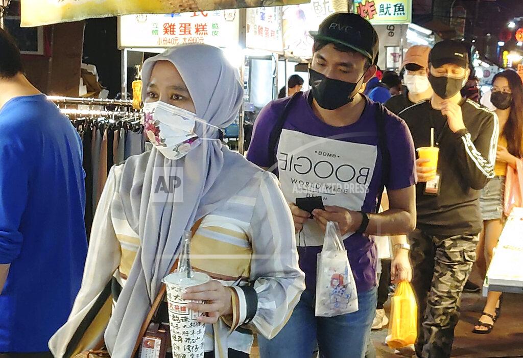 Chiang Ying-Ying People wear face masks to protect against the spread of the coronavirus at a night market in Taipei, Taiwan, Friday, May 14, 2021. (AP Photo/Chiang Ying-ying)