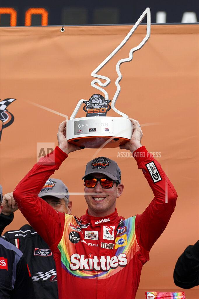 Chuck Burton Kyle Busch raises the trophy in Victory Lane after winning the NASCAR Xfinity Series auto race at the Circuit of the Americas in Austin, Texas, Saturday, May 22, 2021. (AP Photo/Chuck Burton)