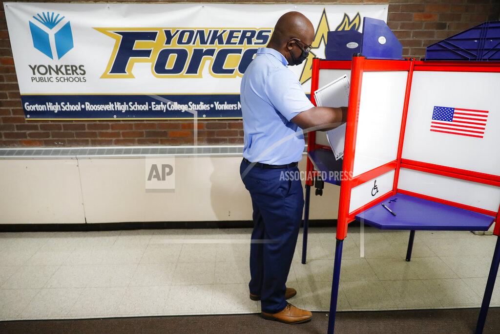 John Minchillo Jamaal Bowman votes at a polling station inside Yonkers Middle/High School, Tuesday, June 23, 2020, in Yonkers, N.Y. Bowman is running against veteran Rep. Eliot Engel in the Democratic primary for New York's 16th Congressional District. (AP Photo/John Minchillo)