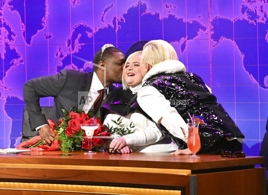 Will Heath This image released by NBC shows Michael Che, left, with Aidy Bryant, center, and Bowen Yang during the "Weekend Update" segment on "Saturday Night Live" in New York on May 21, 2022. (Will Heath/NBC via AP)