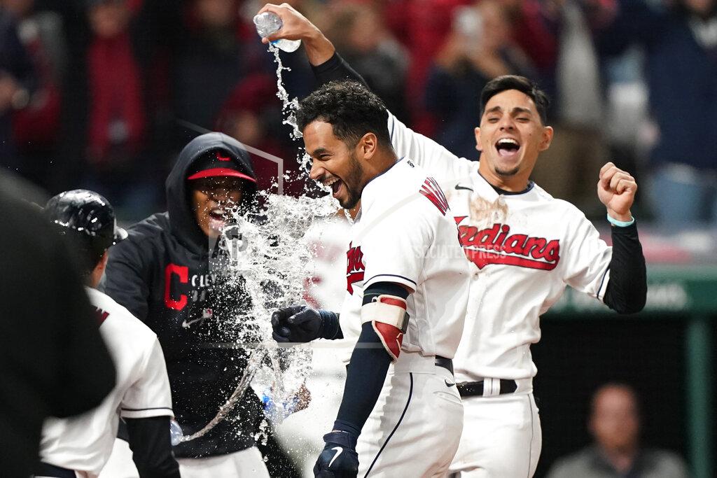 Tony Dejak Cleveland Indians' Oscar Mercado, cdnter, is mobbed by teammates after hitting a two-run home run in the seventh inning in the second baseball game of a doubleheader against the Chicago White Sox, Thursday, Sept. 23, 2021, in Cleveland. (AP Photo/Tony Dejak)