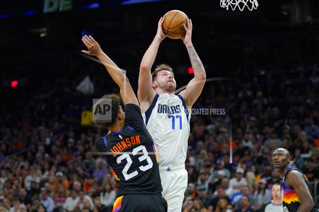 Matt York Dallas Mavericks guard Luka Doncic (77) shoots over Phoenix Suns forward Cameron Johnson (23) during the second half of Game 7 of an NBA basketball Western Conference playoff semifinal, Sunday, May 15, 2022, in Phoenix. The Mavericks defeated the Suns 123-90. (AP Photo/Matt York)