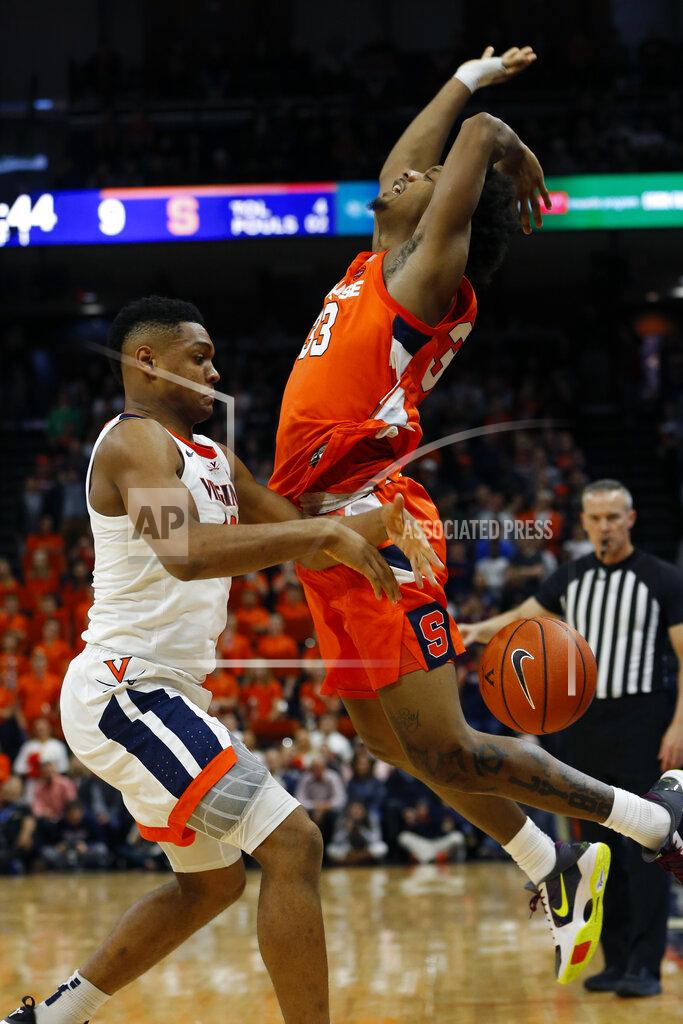 Steve Helber Syracuse forward Elijah Hughes (33) looses the ball as Virginia guard Casey Morsell (13) defends during the first half of an NCAA college basketball game in Charlottesville, Va., Saturday, Jan. 11, 2020. Morsell ws called for a four on the play. (AP Photo/Steve Helber)