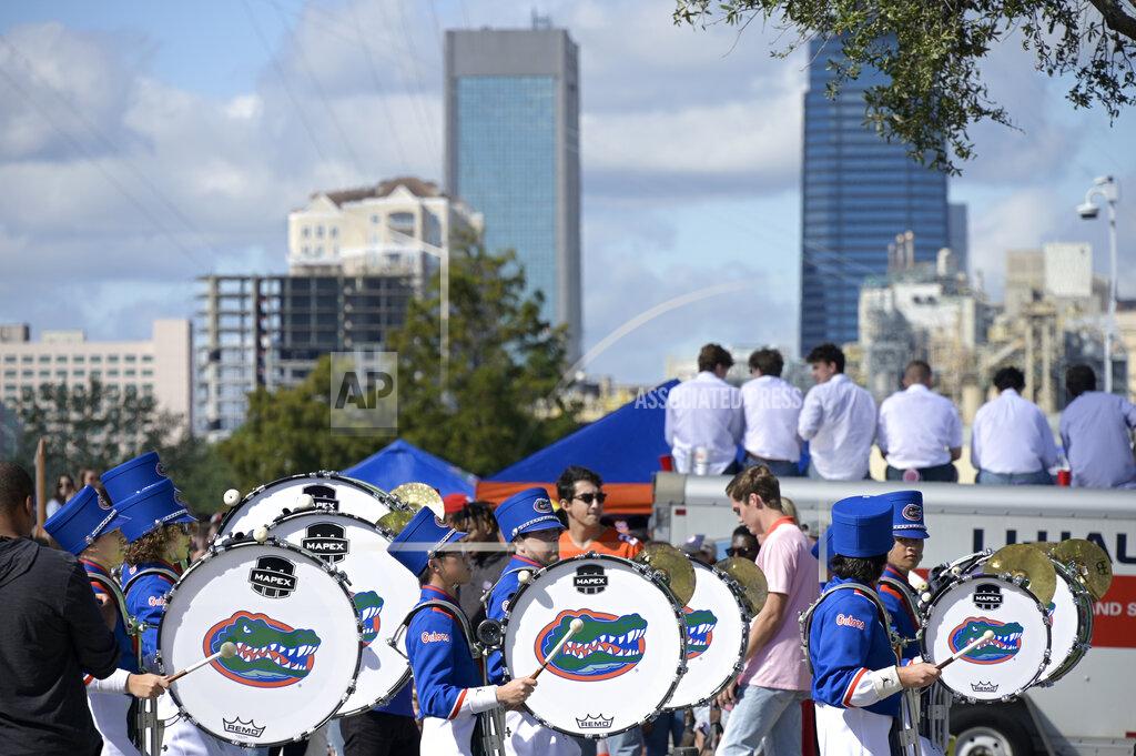 Phelan M. Ebenhack Members of the Florida marching band make their way into the stadium before an NCAA college football game against Georgia, Saturday, Oct. 30, 2021, in Jacksonville, Fla. (AP Photo/Phelan M. Ebenhack)