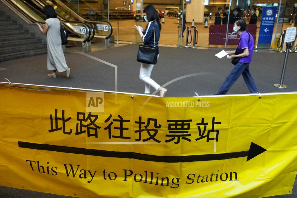 Vincent Yu Voters enter a polling center for the election committee that will vote for the city's leader in Hong Kong Sunday, Sept. 19, 2021. Hong Kong's polls for an election committee that will vote for the city's leader kicked off Sunday amid heavy police presence, with chief executive Carrie Lam saying that it is "very meaningful" as it is the first election to take place following electoral reforms. (AP Photo/Vincent Yu)