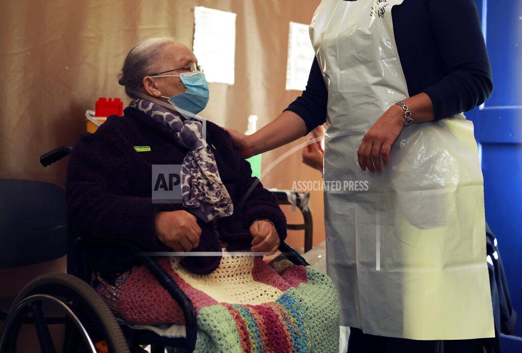 Nardus Engelbrecht Eighty seven year old Catherine Daries receives her first dose of the Pfizer COVID-19 vaccine at a vaccination center, at the Karl Bremer Hospital, in Cape Town, South Africa, Friday, June 11, 2021. South Africa technically entered the third wave of coronavirus infections as the national seven-day moving average incidence now exceeds the new wave threshold as defined by the Ministerial Advisory Committee. (AP Photo/Nardus Engelbrecht)