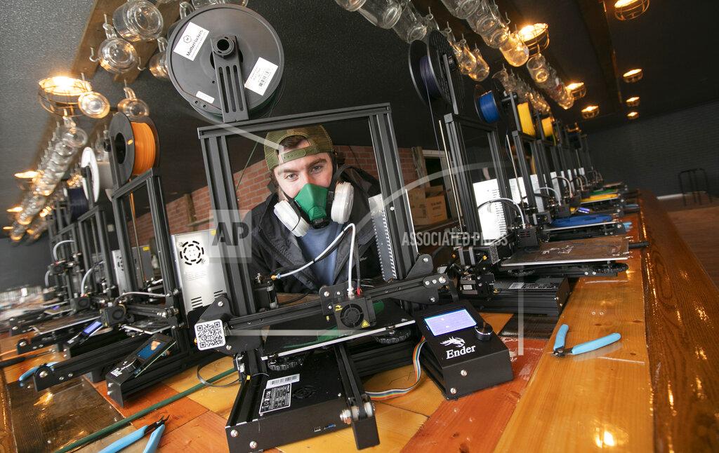 Nikolas Thomson, of Southington, is making 3-D printed face shields and other protective equipment for healthcare workers and first responders, Friday, Apr. 17, 2020 in Southington, Conn. The three have set up shop in the building previously occupied by Hop Knot craft beer and gourmet pretzel bar on Meriden-Waterbury Turnpike in Plantsville. (Dave Zajac/Record-Journal via AP)