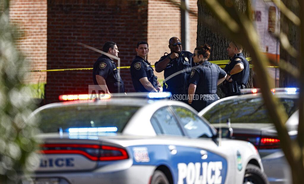 Wade Payne Knoxville police work the scene following a shooting at Austin-East Magnet High School in Knoxville, Tenn., Monday, April 12, 2021. (AP Photo/Wade Payne)