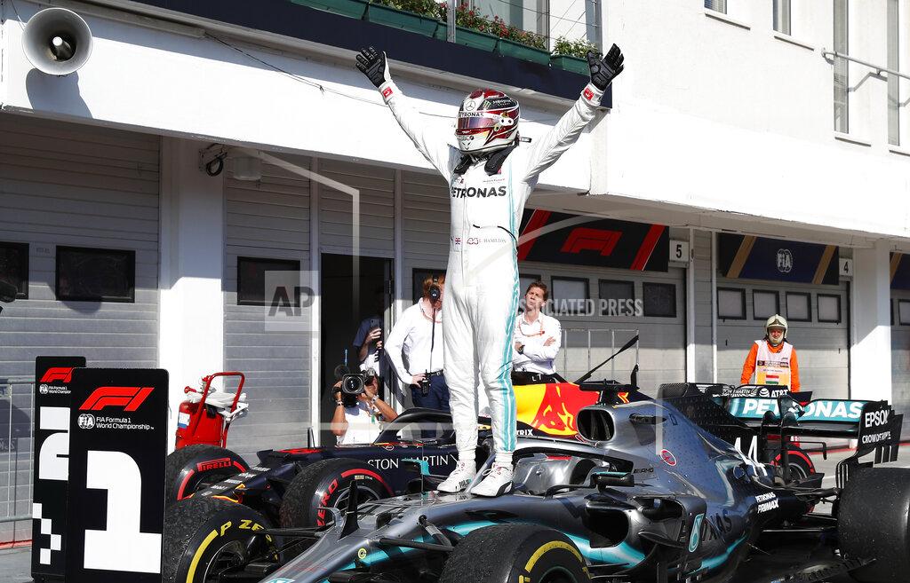 Laszlo Balogh Mercedes driver Lewis Hamilton of Britain celebrates after winning the Hungarian Formula One Grand Prix at the Hungaroring racetrack in Mogyorod, northeast of Budapest, Hungary, Sunday, Aug. 4, 2019. (AP Photo/Laszlo Balogh)