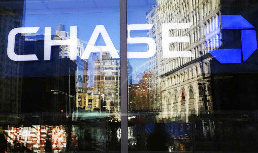 Mark Lennihan FILE- This Jan. 11, 2016, file photo shows a Chase bank branch in New York. The coronavirus pandemic is weighing heavily on the financial health of JPMorgan Chase. The nation’s largest financial company said Tuesday, July 14, 2020, that it set aside billions of dollars in the second quarter to cover potential losses from all the businesses and consumers who are unable to pay their debts due to the slumping U.S. economy. (AP Photo/Mark Lennihan, File)