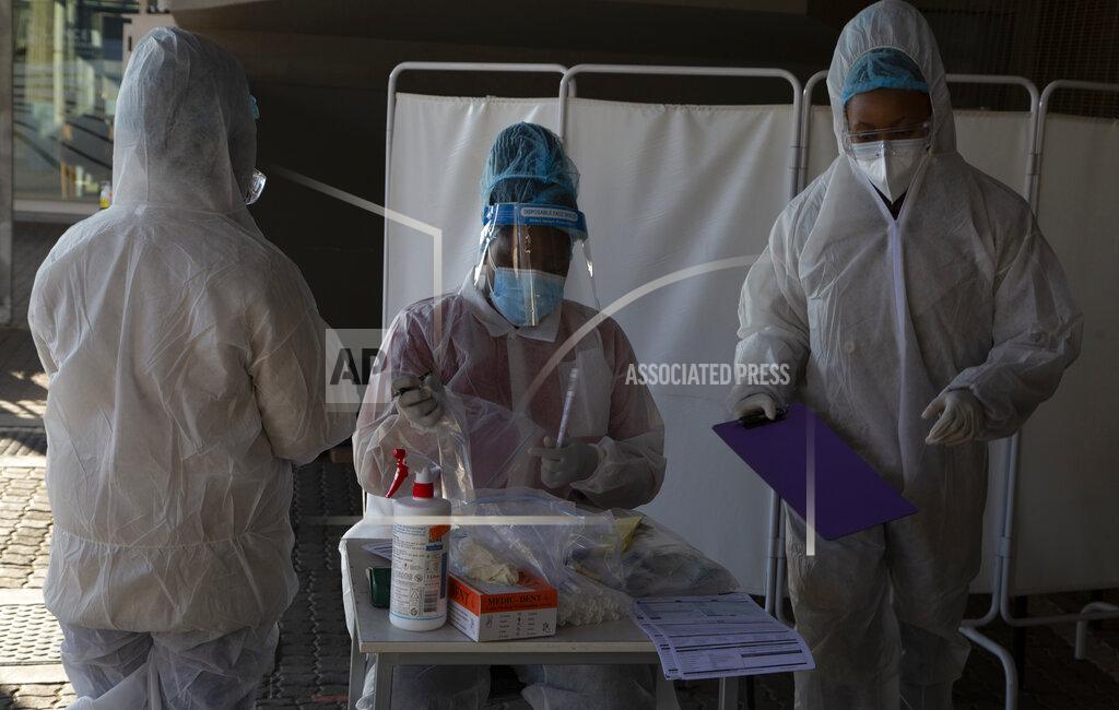 Denis Farrell FILE - In this Tuesday, June 22, 2021 file photo, healthcare workers prepare to test patients for COVID-19 at the Lancet Laboratories in Johannesburg. Africa is facing a devastating resurgence of COVID-19 infections whose peak will surpass that of earlier waves as the continent's countries struggle to vaccinate even a small percentage of the population, top health officials said Thursday June 24, 2021. (AP Photo/Denis Farrell, File)