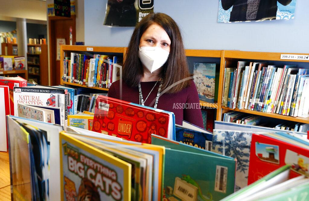 Brian Hill Emerson Elementary School librarian Lauren Blanford poses for a photo Wednesday Feb. 24, 2021 in Elmhurst, Ill. (Brian Hill/Daily Herald via AP)