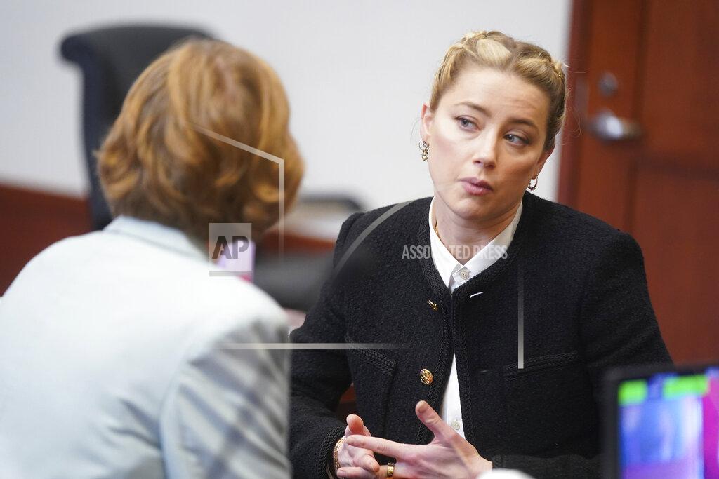 Shaw Thew Actor Amber Heard talks to her attorneys in the courtroom at the Fairfax County Circuit Courthouse in Fairfax, Va., Thursday, May 19, 2022. Actor Johnny Depp sued his ex-wife Amber Heard for libel in Fairfax County Circuit Court after she wrote an op-ed piece in The Washington Post in 2018 referring to herself as a "public figure representing domestic abuse." (Shawn Thew/Pool photo via AP)