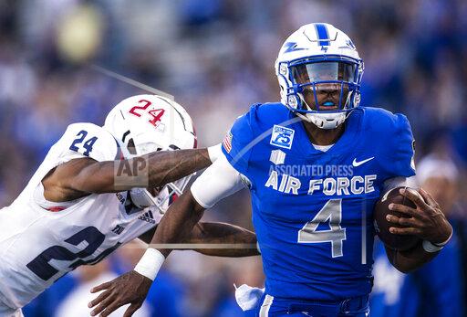 Air Force quarterback Haaziq Daniels (4) dodges Florida Atlantic cornerback Zyon Gilbert (24) as he runs in for a touchdown during an NCAA college football game at Air Force Academy, Colo., on Saturday, Sept. 25, 2021. (Chancey Bush/The Gazette via AP)