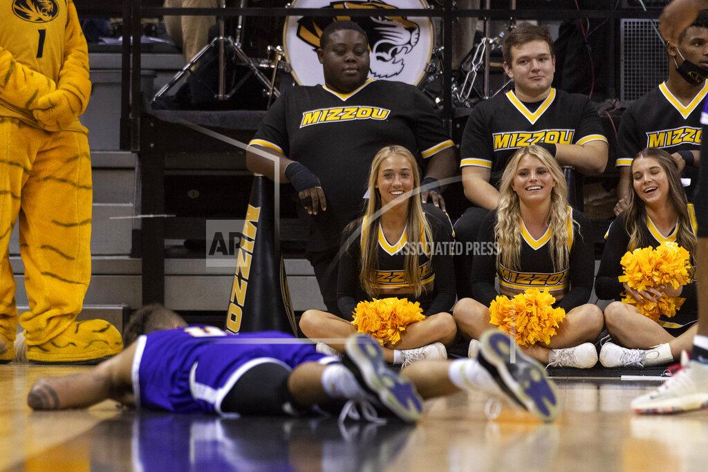 L.g. Patterson Missouri cheerleaders, right, laugh with Paul Quinn's Brandon Johnson, left as he lies on the court after losing the ball out of bounds during the second half of an NCAA college basketball game Monday, Nov. 29, 2021, in Columbia, Mo. (AP Photo/L.G. Patterson)