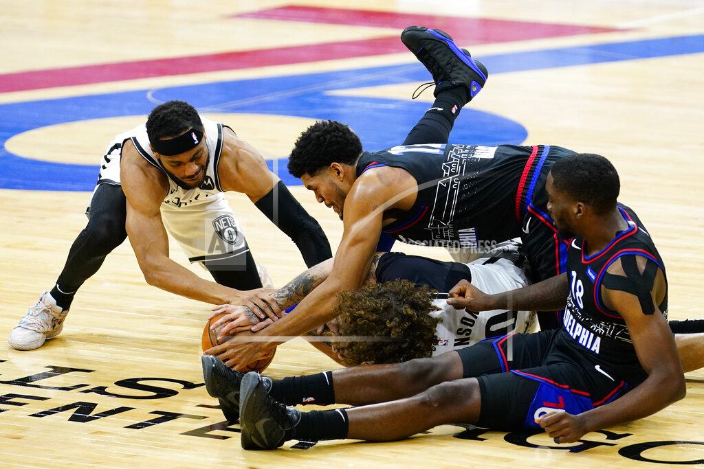 Matt Slocum Brooklyn Nets' Bruce Brown, left, and Iman Shumpert, middle, battle for a loose ball with Philadelphia 76ers' Tobias Harris, top, and Shake Milton, right, during the first half of an NBA basketball game, Saturday, Feb. 6, 2021, in Philadelphia. (AP Photo/Matt Slocum)