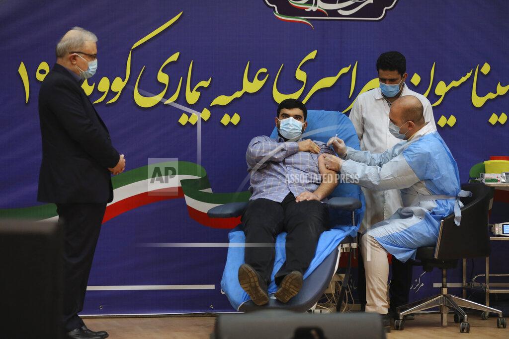 Vahid Salemi FILE— In this Feb. 9, 2021, file photo, Parsa Namaki, center, son of Health Minister Saeed Namaki, left, is injected with the Russian Sputnik V coronavirus vaccine in a staged event at Imam Khomeini hospital in Tehran, Iran, Iran. Iran has finalized a deal with Russia over purchasing 60 million doses Sputnik V Coronavirus vaccine, state-run IRNA news agency reported Thursday, April 15, 2021. (AP Photo/Vahid Salemi, File)