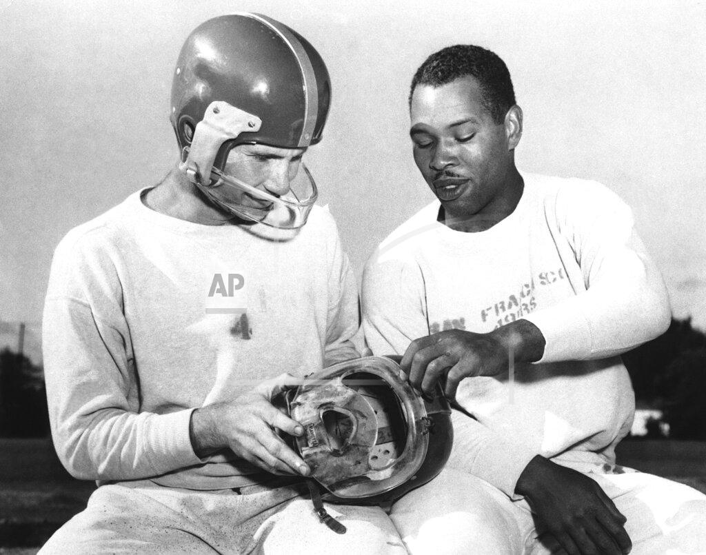 Anonymous FILe - In this, San Francisco 49ers fullback Joe Perry, right, shows quarterback Y. A. Tittle the plastic mask he has worn during the football season to protect his bridgework, during practice at Menlo Park, Calif. Tittle, who suffered a cheekbone fracture against the Detroit Lions, is wearing the mask he has used since. Helmets have evolved from the original hard leather of the NFL’s infancy to hard polycarbonate single-piece shells with various amounts of padding and air bladders that served as the primary form of head protection into the beginning of this century. (AP Photo/File)