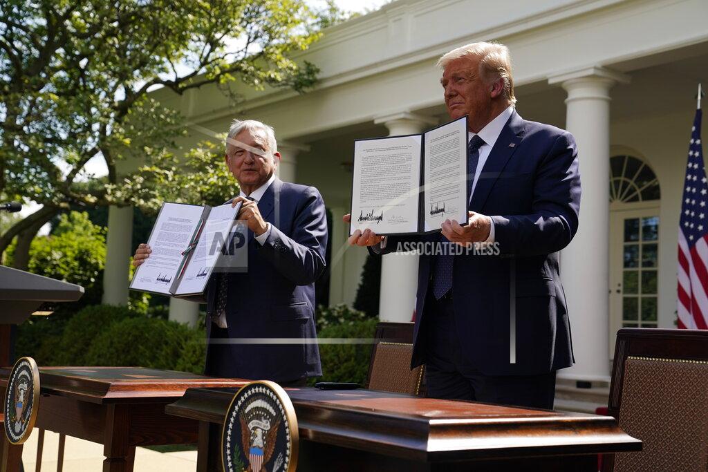 Evan Vucci President Donald Trump and Mexican President Andres Manuel Lopez Obrador pose for photos after signing a joint declaration at the White House, Wednesday, July 8, 2020, in Washington. (AP Photo/Evan Vucci)